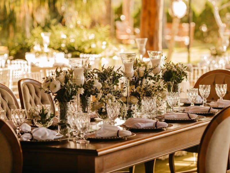 Elegant wedding reception table setting with floral centerpiece
